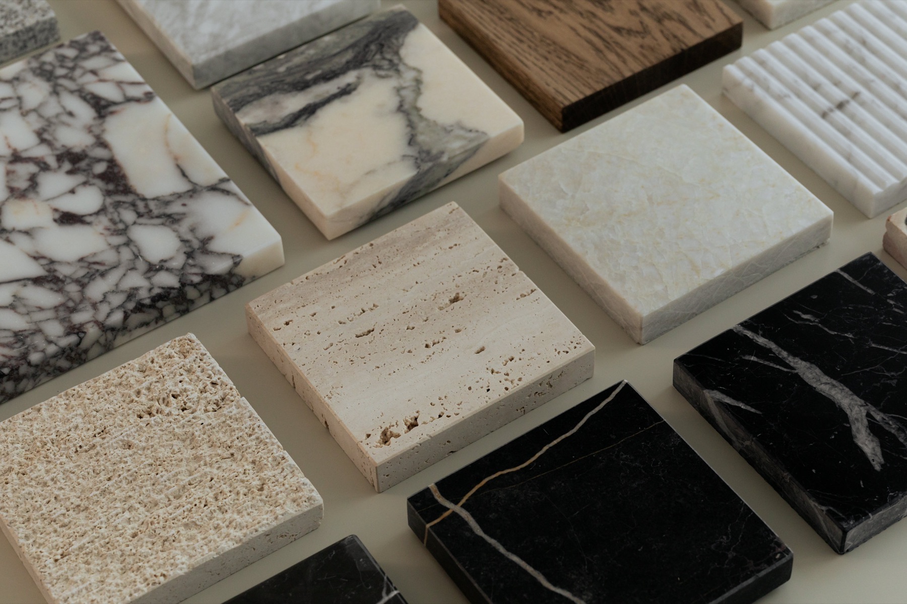Marble, travertine, limestone and oak samples laid out for a consultation