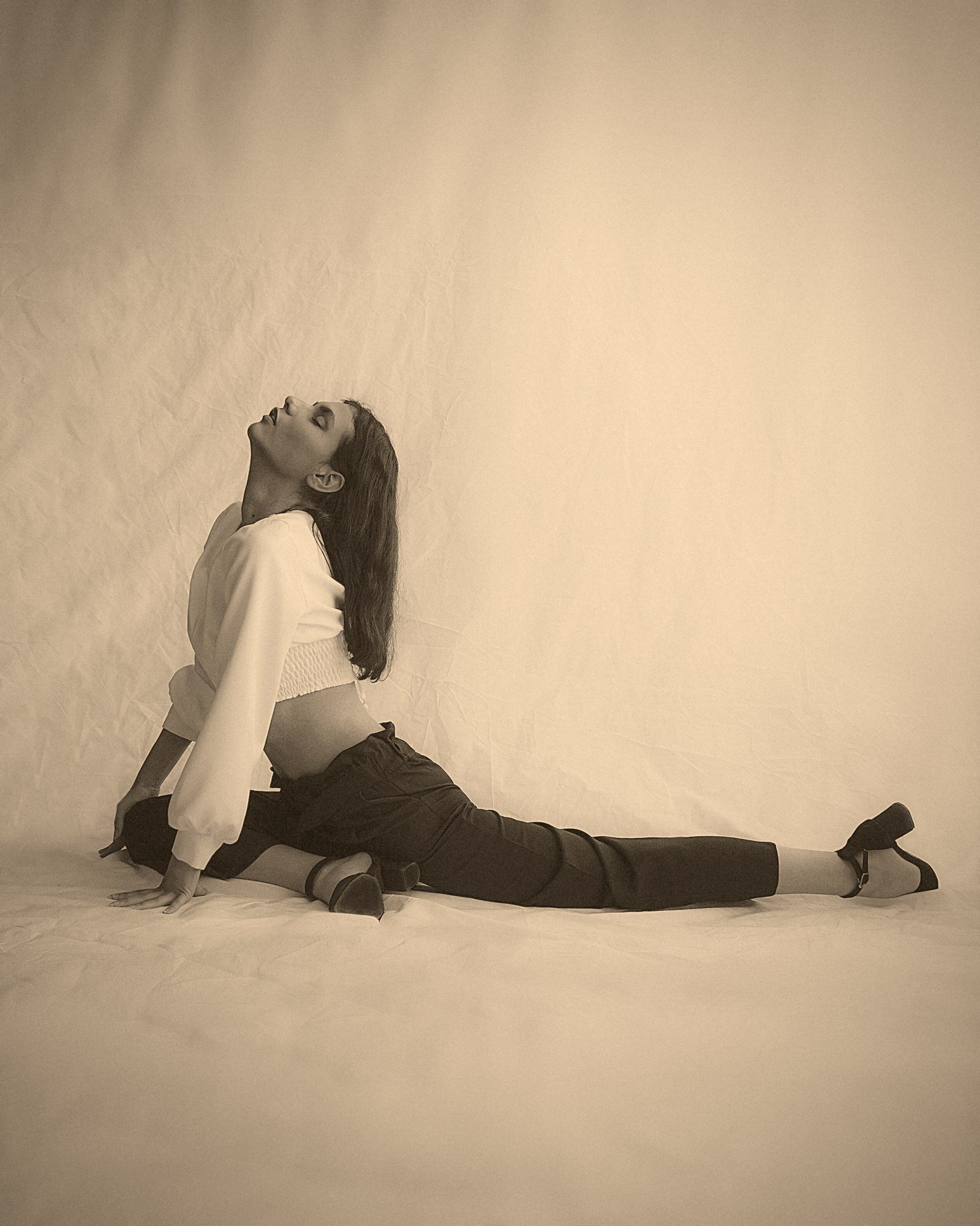 Leila Amari, founder of Sunhouse Yoga, in a deep seated stretch