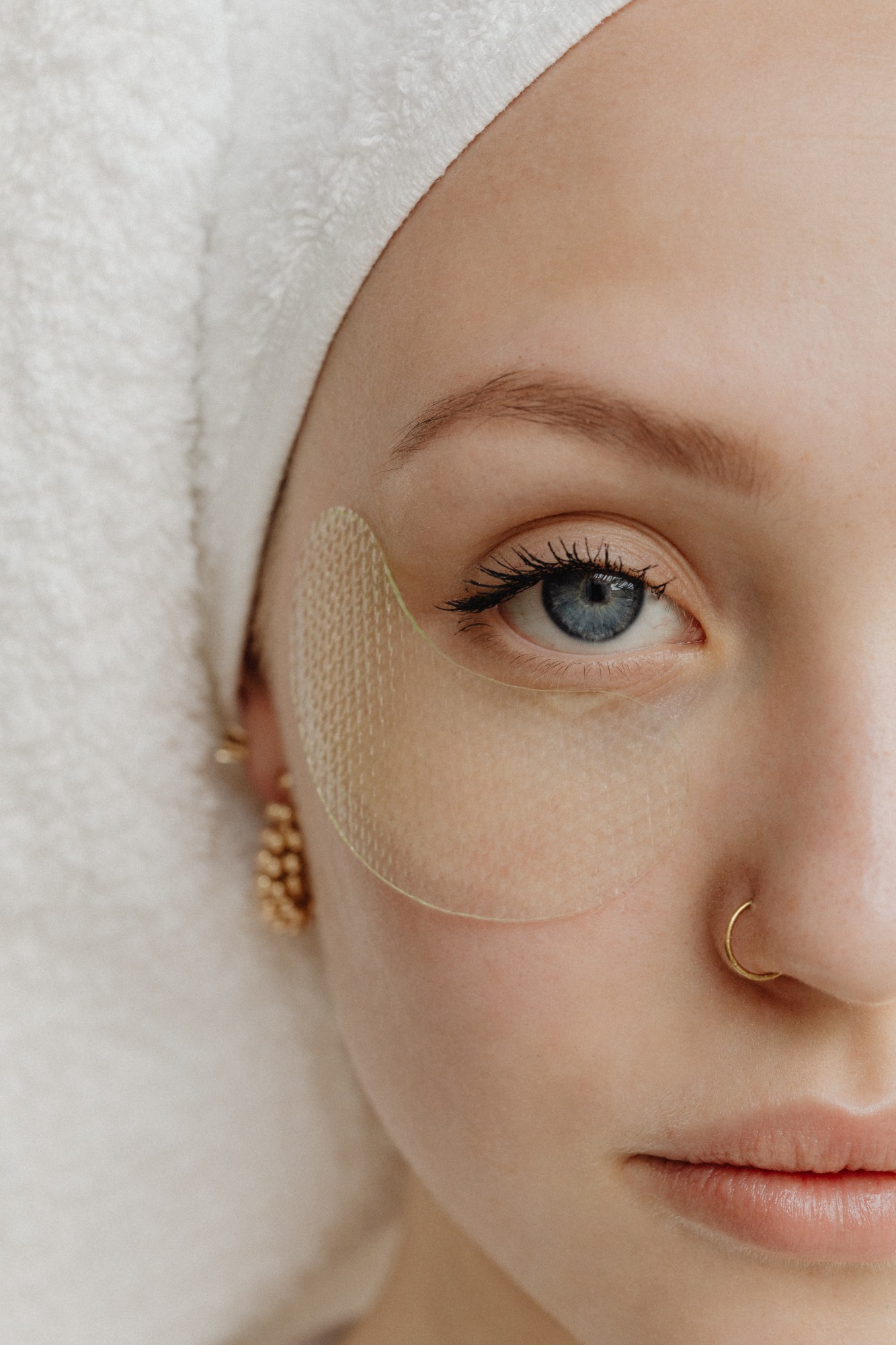 Close view of a hydrogel eye patch beneath a blue eye