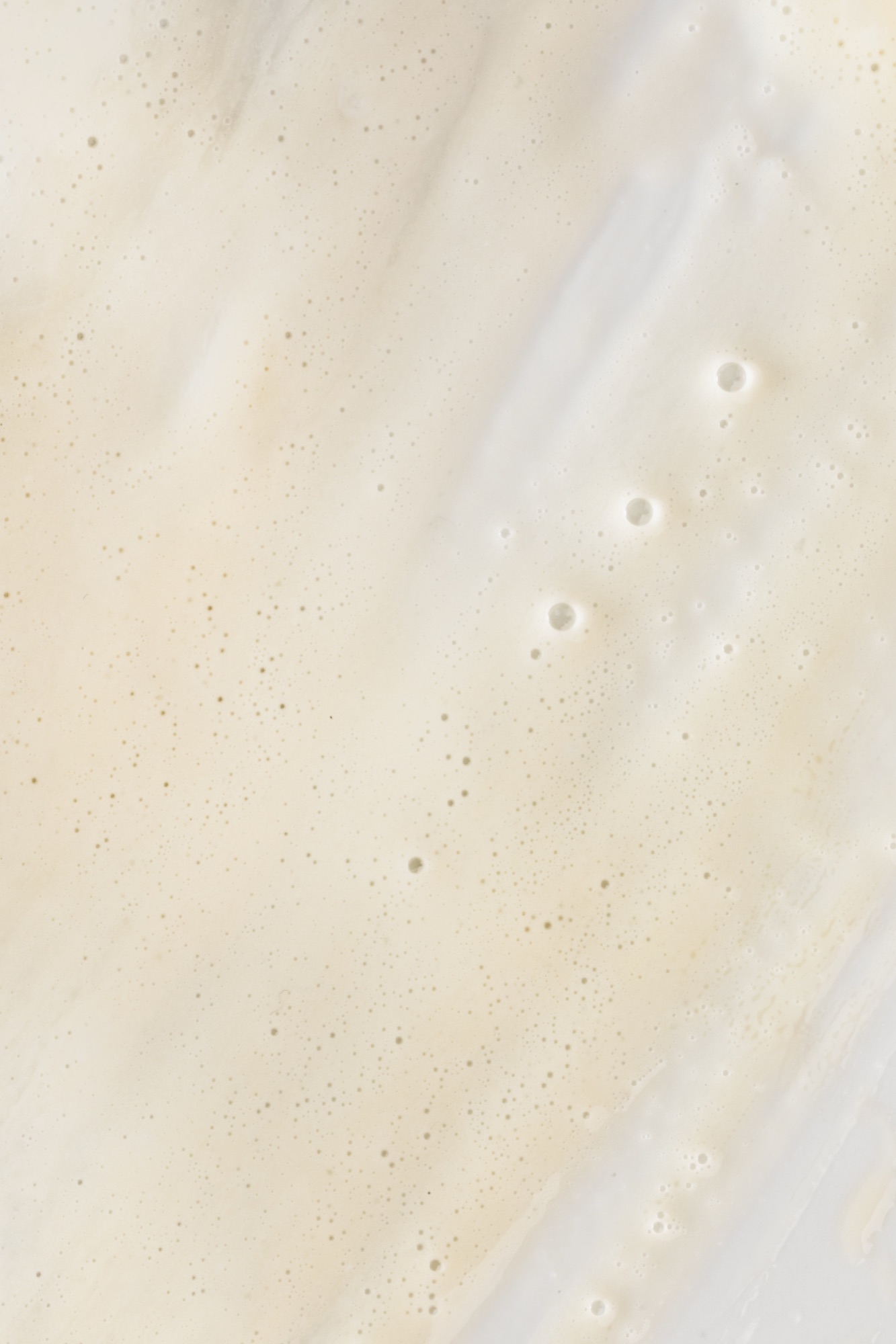 Off-white cleansing milk with fine bubbles